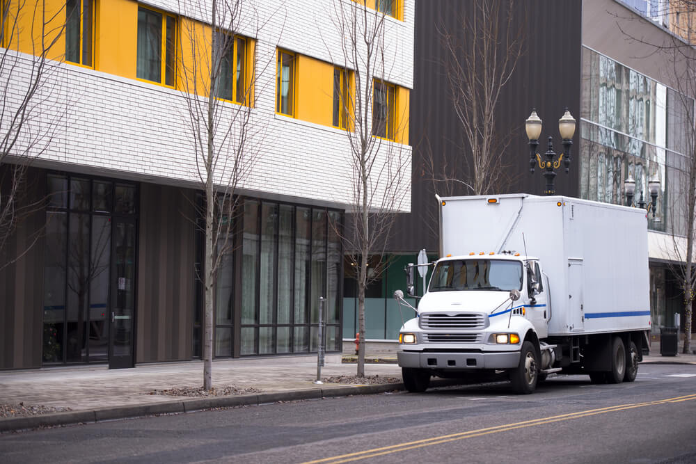 Small compact semi truck with a box trailer body