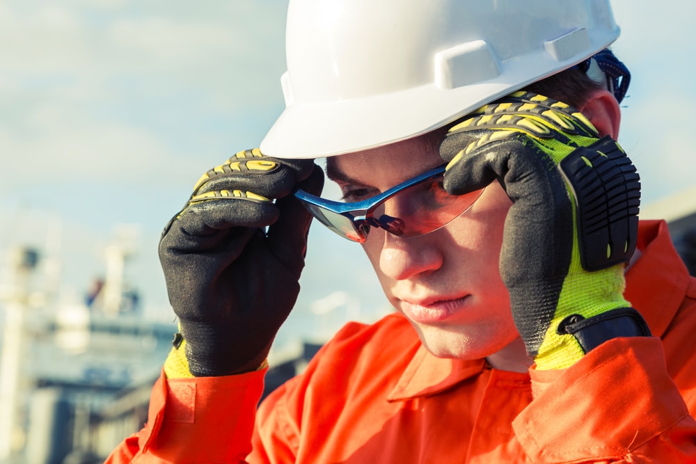 Orange-robe-engineer-wearing-safety-glasses
