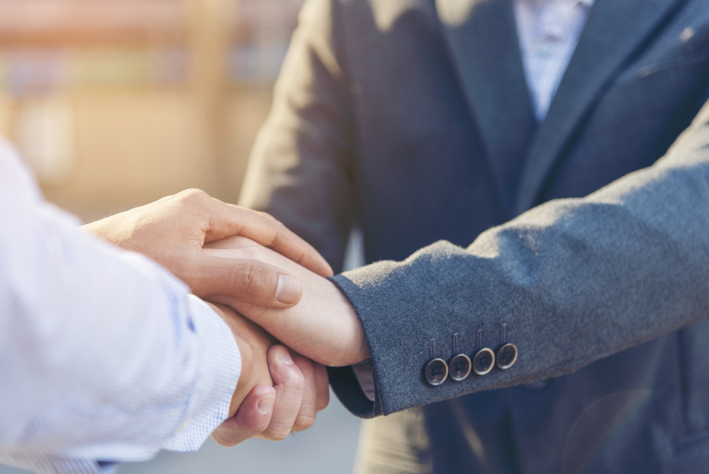 closeup-of-two-men-shaking-hands