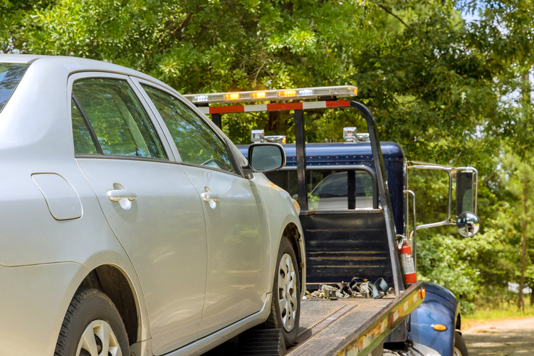 if a tow truck damages your car are they liable