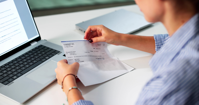 woman holding check - can a personal injury settlement be garnished?