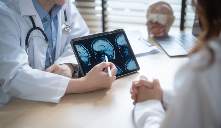 Doctor pointing at a portion of a brain scan - The types of brain injuries possible from car accidents