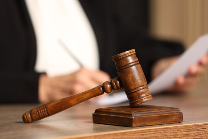 Judge working with document next to a mallet on a table - how many personal injury cases go to trial?