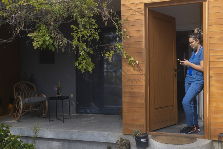 Woman leaning against her house - Can I lose my house due to an at-fault car accident?