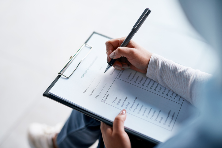 Person filling out medical document - San Luis Obispo workers' compensation attorney
